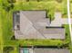 Aerial view of a home featuring a screened-in pool, well-manicured lawn, and paved driveway at 8968 Artisan Way, Sarasota, FL 34240