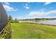 Lush backyard with scenic water views and vibrant landscaping at 8968 Artisan Way, Sarasota, FL 34240