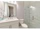 Bright bathroom featuring a glass shower, white vanity, and modern fixtures at 8968 Artisan Way, Sarasota, FL 34240