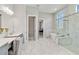 Elegant primary bathroom boasts dual sinks, large tub, and walk-in shower at 8968 Artisan Way, Sarasota, FL 34240