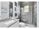 Modern bathroom featuring a glass shower, gray vanity, and unique tile at 8968 Artisan Way, Sarasota, FL 34240