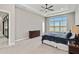 Large bedroom featuring a ceiling fan, spacious closet, and neutral decor at 8968 Artisan Way, Sarasota, FL 34240