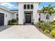 Elegant front entrance featuring double doors, sidelights, and a manicured landscape in a beautiful home at 8968 Artisan Way, Sarasota, FL 34240