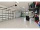 Spacious three car garage featuring epoxy flooring and ample storage at 8968 Artisan Way, Sarasota, FL 34240