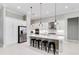 Modern kitchen with stainless steel appliances, island with seating, and ample cabinet space at 8968 Artisan Way, Sarasota, FL 34240