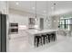 Modern kitchen with a large island, stainless steel appliances, and an open layout perfect for entertaining at 8968 Artisan Way, Sarasota, FL 34240