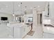 Beautiful kitchen island with stainless steel sink, pendant lights, and modern appliances in an open layout at 8968 Artisan Way, Sarasota, FL 34240