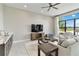 Open living area with comfortable seating, entertainment center, and a water view at 8968 Artisan Way, Sarasota, FL 34240
