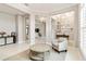 Elegant living room with gray accents, crown molding, and views of other parts of the home at 8968 Artisan Way, Sarasota, FL 34240