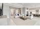 Open-concept floor plan with living area flowing into kitchen, featuring modern finishes and plenty of natural light at 8968 Artisan Way, Sarasota, FL 34240