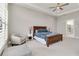 Spacious main bedroom with a ceiling fan, chair, and ensuite bathroom at 8968 Artisan Way, Sarasota, FL 34240