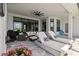 Spacious screened patio with lounge chairs, seating area, and tranquil outdoor living at 8968 Artisan Way, Sarasota, FL 34240
