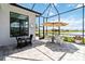Inviting screened patio with outdoor dining and seating area overlooking the water at 8968 Artisan Way, Sarasota, FL 34240