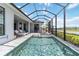 Outdoor screened in patio with furniture and an umbrella at 8968 Artisan Way, Sarasota, FL 34240
