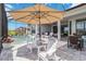 Covered patio area with a pool and lounge chairs at 8968 Artisan Way, Sarasota, FL 34240