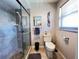Bathroom with step-in shower featuring glass doors and modern fixtures at 931 Juno Dr, Punta Gorda, FL 33950