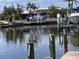 View of canal with dock; featuring boats, a lift, and waterfront homes at 931 Juno Dr, Punta Gorda, FL 33950