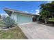 Single-story home featuring a two-car garage, tidy landscaping and a spacious driveway at 931 Juno Dr, Punta Gorda, FL 33950