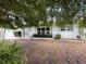 Charming single-story home with a light blue exterior, well-kept landscaping, and inviting front entrance at 931 Juno Dr, Punta Gorda, FL 33950