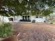 Charming single-story home with a light blue exterior, well-kept landscaping, and inviting front entrance at 931 Juno Dr, Punta Gorda, FL 33950