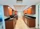 Galley kitchen with stone counter tops and stainless appliances at 931 Juno Dr, Punta Gorda, FL 33950