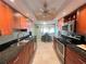Updated kitchen features wood cabinets, black granite countertops, stainless appliances, and eat-in breakfast nook with view at 931 Juno Dr, Punta Gorda, FL 33950