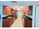 Bright kitchen with stainless steel appliances, granite countertops, and plentiful wooden cabinetry at 931 Juno Dr, Punta Gorda, FL 33950