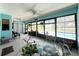 Enclosed lanai with bright decor, tile flooring, and picturesque water views at 931 Juno Dr, Punta Gorda, FL 33950