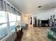 Bright and airy living room with tile flooring, large windows, and tastefully decorated with comfortable seating at 931 Juno Dr, Punta Gorda, FL 33950