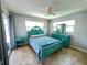 Bright bedroom features neutral walls and an aqua bedroom set, complemented by tile flooring at 931 Juno Dr, Punta Gorda, FL 33950