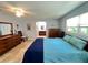 Comfortable main bedroom with tiled floor, ceiling fan, and ensuite bathroom at 931 Juno Dr, Punta Gorda, FL 33950