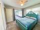 Bedroom featuring sliding glass door to porch, neutral walls, and tile floors at 931 Juno Dr, Punta Gorda, FL 33950