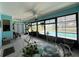 A bright enclosed patio features tile flooring, outdoor views, and a dining area at 931 Juno Dr, Punta Gorda, FL 33950