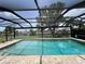 Beautiful screened pool with clear blue water and scenic views of the waterfront property at 931 Juno Dr, Punta Gorda, FL 33950