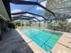 A screened pool with a brick surround and tranquil outdoor space at 931 Juno Dr, Punta Gorda, FL 33950