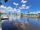 Scenic waterfront view with docks and beautiful waterfront homes under a sunny sky at 931 Juno Dr, Punta Gorda, FL 33950