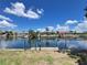 Idyllic waterfront setting featuring private docks, well-kept landscaping, and peaceful canal waters under a sunny sky at 931 Juno Dr, Punta Gorda, FL 33950