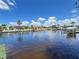 Tranquil waterfront homes with docks on a sunny day featuring the canal with boats docked and lush green landscaping at 931 Juno Dr, Punta Gorda, FL 33950