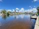 Beautiful waterfront homes featuring a calm canal, lush tropical foliage and boat docks in a sunny, tropical landscape at 931 Juno Dr, Punta Gorda, FL 33950