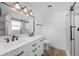 Modern bathroom featuring a dual sink vanity, stylish lighting, and a glass shower at 1020 Drury Ln, Englewood, FL 34224