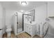 Modern bathroom with white vanity, a framed mirror, and a glass-door shower at 1020 Drury Ln, Englewood, FL 34224