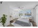 Bright bedroom featuring large windows with views, creating a relaxing ambiance with soft, neutral tones at 1020 Drury Ln, Englewood, FL 34224