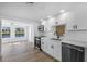 Beautiful kitchen with stainless steel appliances, white cabinetry, and modern fixtures at 1020 Drury Ln, Englewood, FL 34224