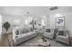 Bright open-concept living room showcasing a modern design with fresh, white interior and an open layout to the kitchen at 1020 Drury Ln, Englewood, FL 34224