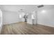 Open-concept living space with hardwood floors, ceiling fan, and view to kitchen at 1020 Drury Ln, Englewood, FL 34224