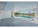 Enclosed pool area featuring a beautiful view of the serene canal and abundant natural light at 1020 Drury Ln, Englewood, FL 34224