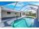 Enclosed pool with a clear view of the surrounding yard, perfect for relaxation at 1020 Drury Ln, Englewood, FL 34224