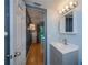Well-lit bathroom features a modern vanity with a gray countertop, complemented by a stylish mirror and lighting at 1051 Forrest Nelson Blvd # 104, Port Charlotte, FL 33952