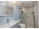 Clean bathroom featuring glass-enclosed shower with a grab bar, neutral color palette, and a sleek vanity at 1051 Forrest Nelson Blvd # 104, Port Charlotte, FL 33952