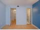A serene bedroom with light blue walls, wood floors, and convenient access to a walk-in closet and bathroom at 1051 Forrest Nelson Blvd # 104, Port Charlotte, FL 33952